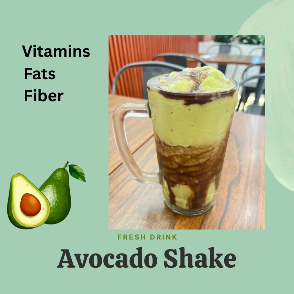 Fresh green avocado juice in a glass beside a sliced avocado, highlighting vitamins, fiber, and healthy fats, styled as a nutritious avocado shake.