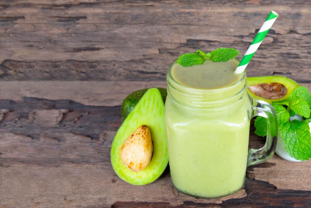 Creamy Avocado Energy Drink served in a glass with fresh avocado slices